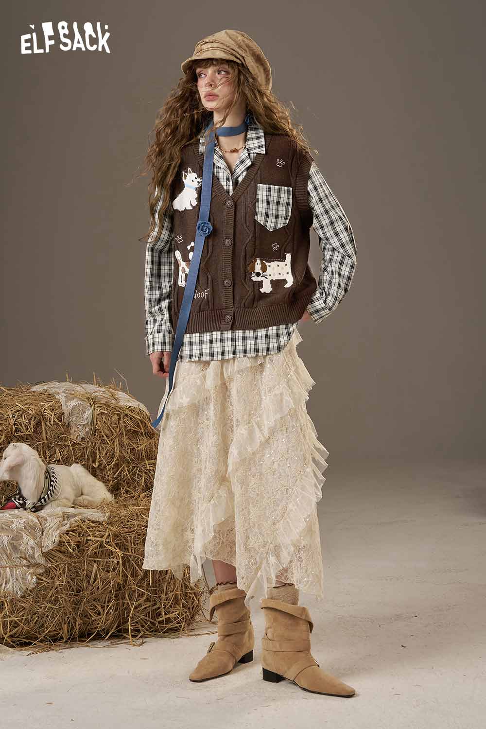 Playful embroidered knit top by ELFSACK paired with a patterned vest and a ruffled skirt