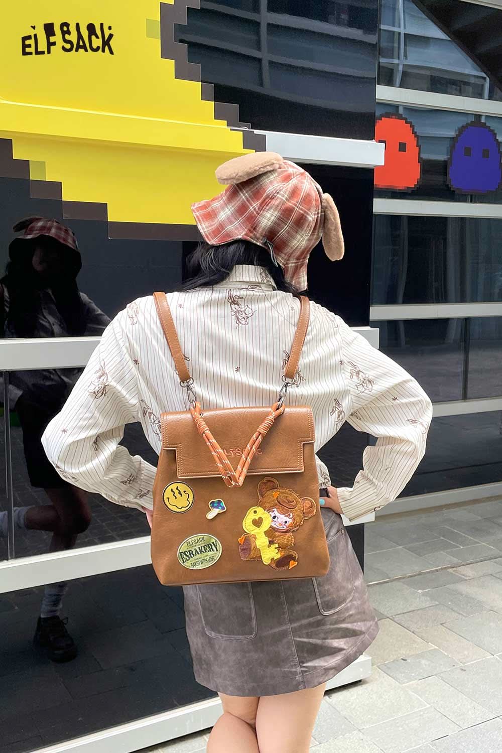 Stylish plush ear tartan bucket hat from ELFSACK worn with a trendy outfit and backpack