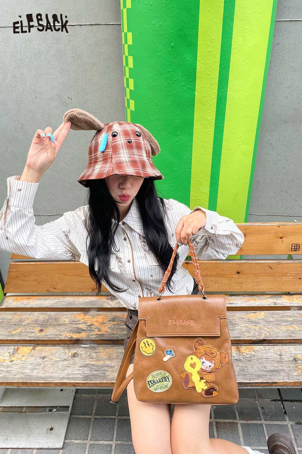 ELFSACK plush ear tartan bucket hat with bunny ears, styled with a trendy outfit and handbag