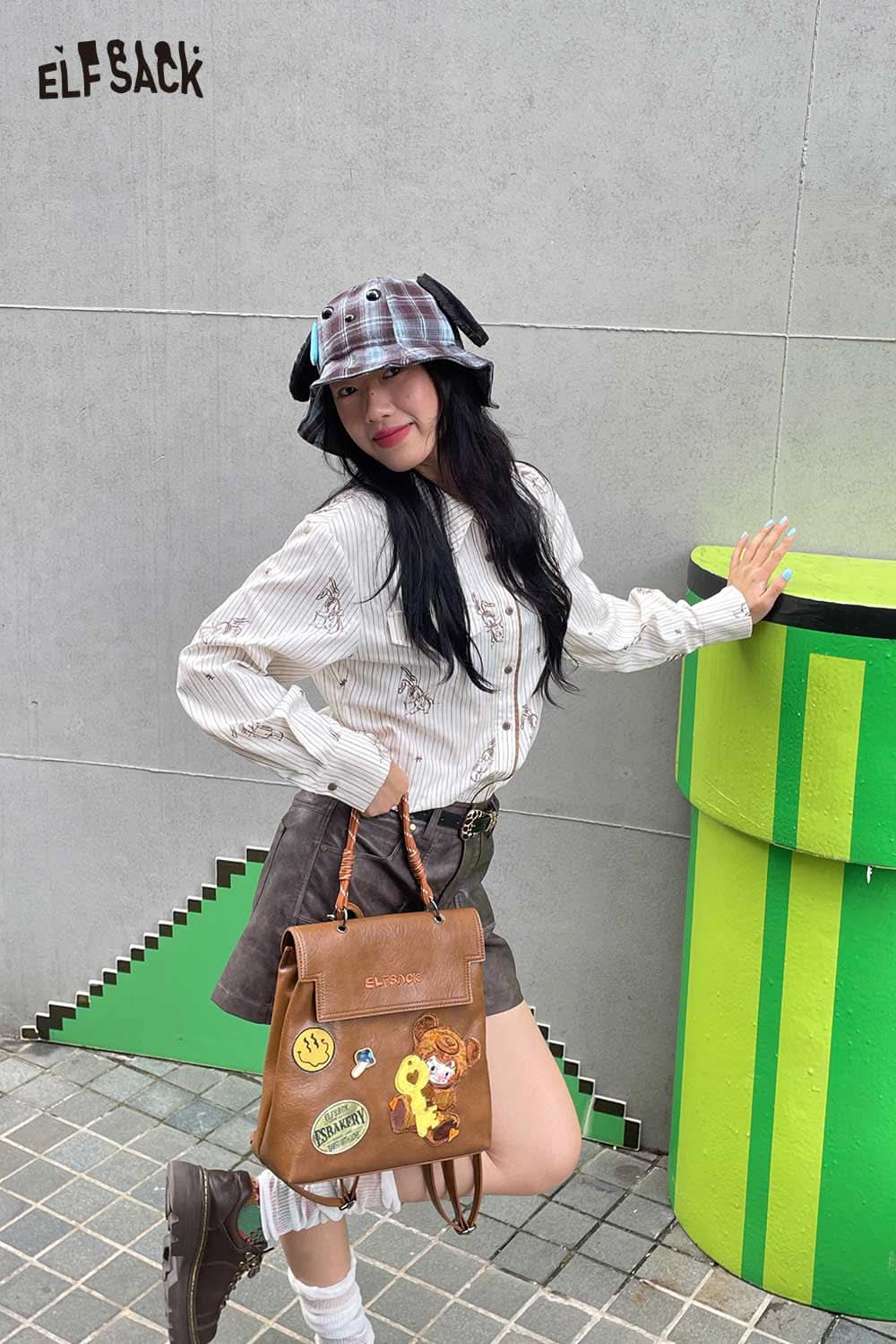Fashionable plush ear tartan bucket hat paired with a stylish outfit and backpack