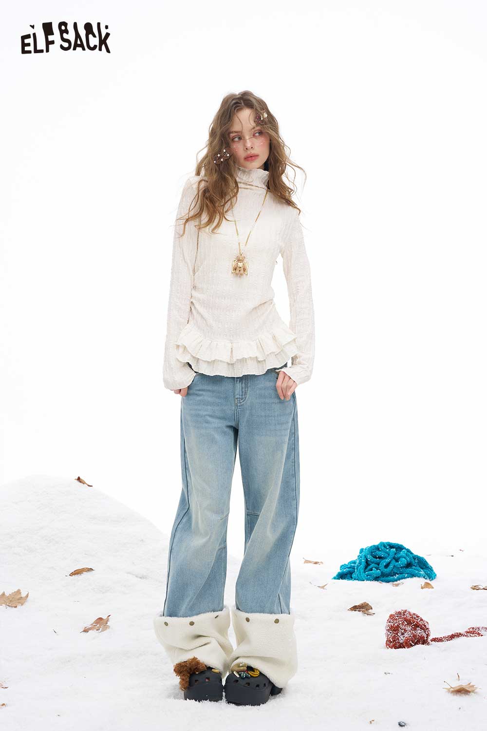 ELFSACK plush hem patchwork jeans with a relaxed fit, styled with a cream top and set against a snowy backdrop