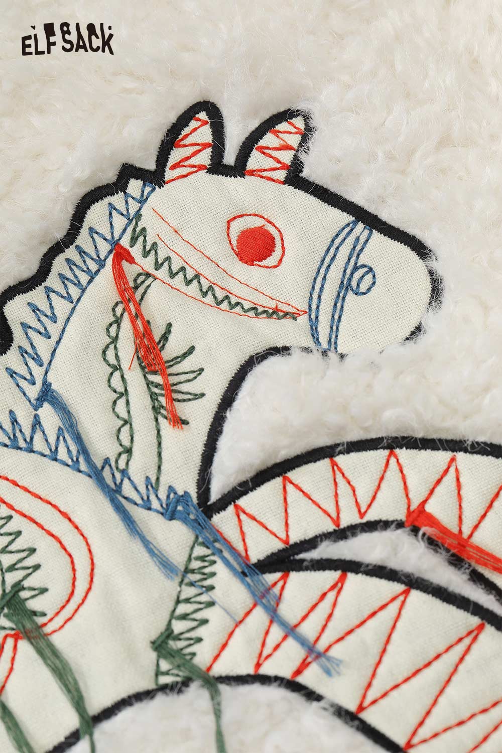 Close-up of pony embroidered plush sweatshirt by ELFSACK featuring colorful detailed stitching on soft fabric