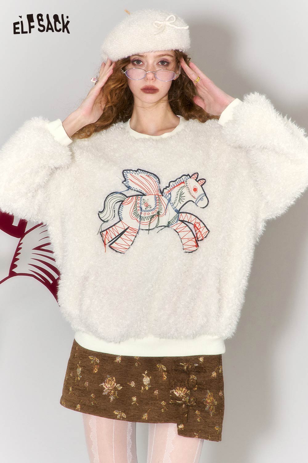 ELFSACK pony embroidered plush sweatshirt in white, featuring a colorful pony design on a cozy fabric