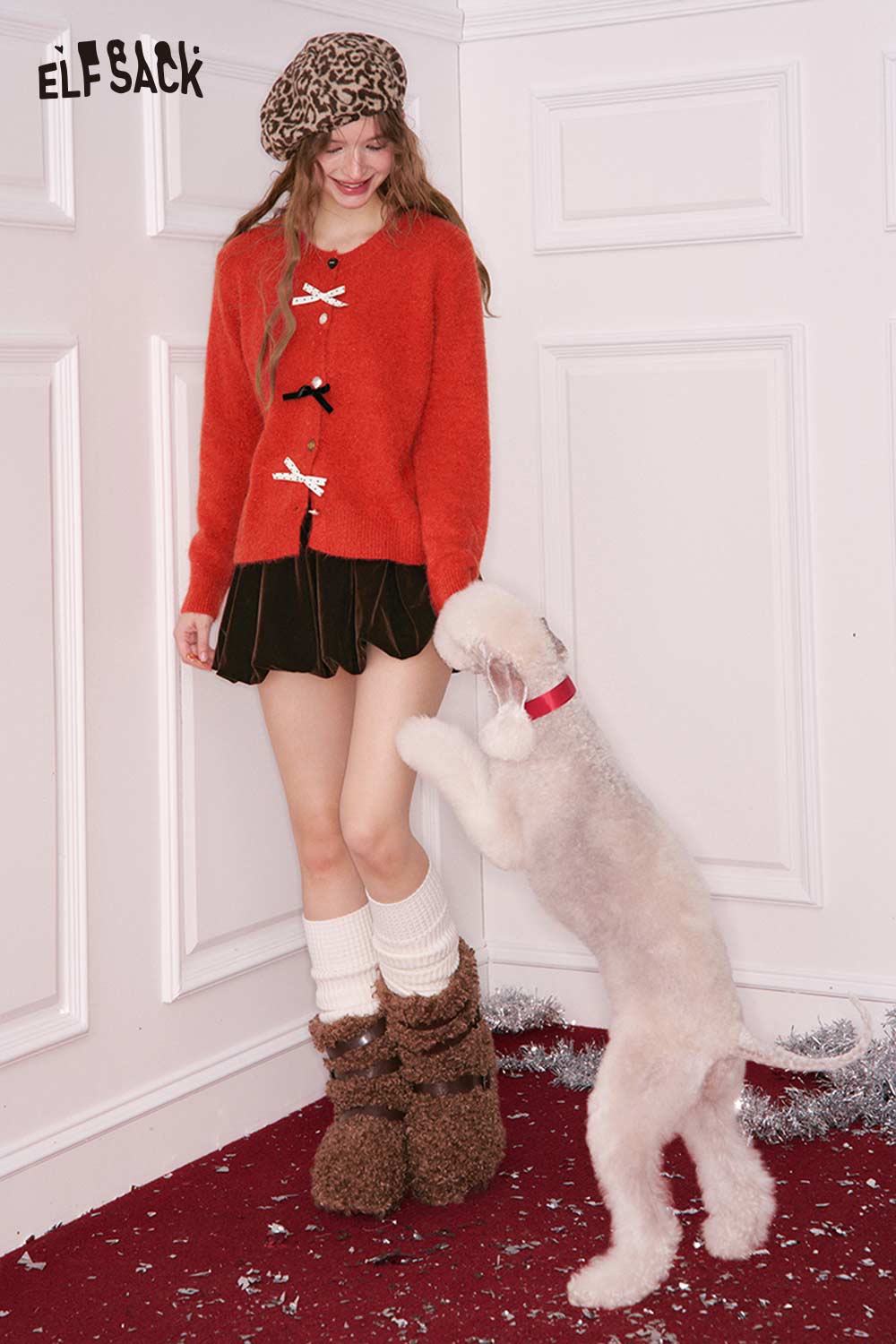 ELFSACK preppy 3D bow cardigan in orange, styled with a skirt and cozy winter boots