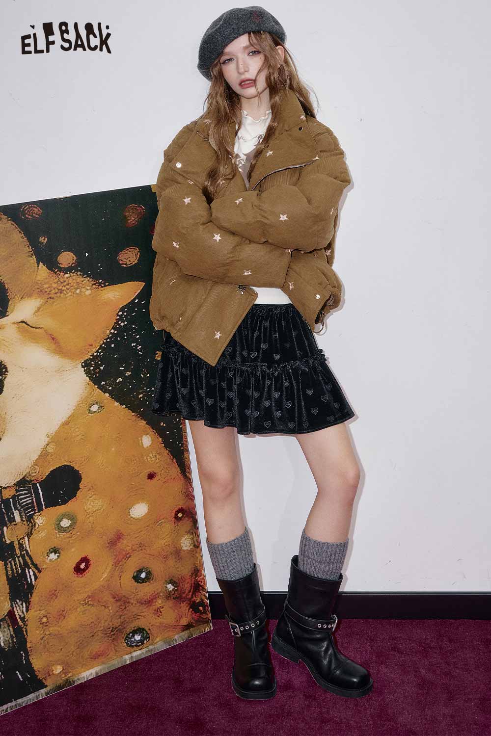 Fashionable model wearing a preppy black velvet mini skirt paired with a stylish outerwear and accessories
