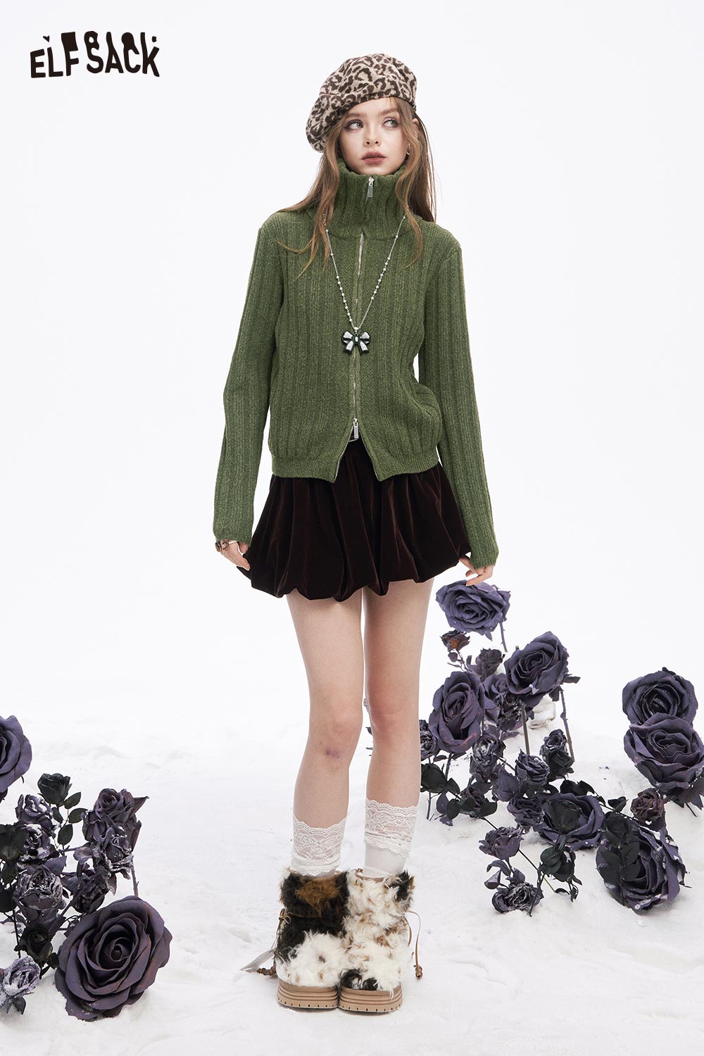 ELFSACK preppy zip up ribbed sweater in green paired with a stylish skirt and accessories
