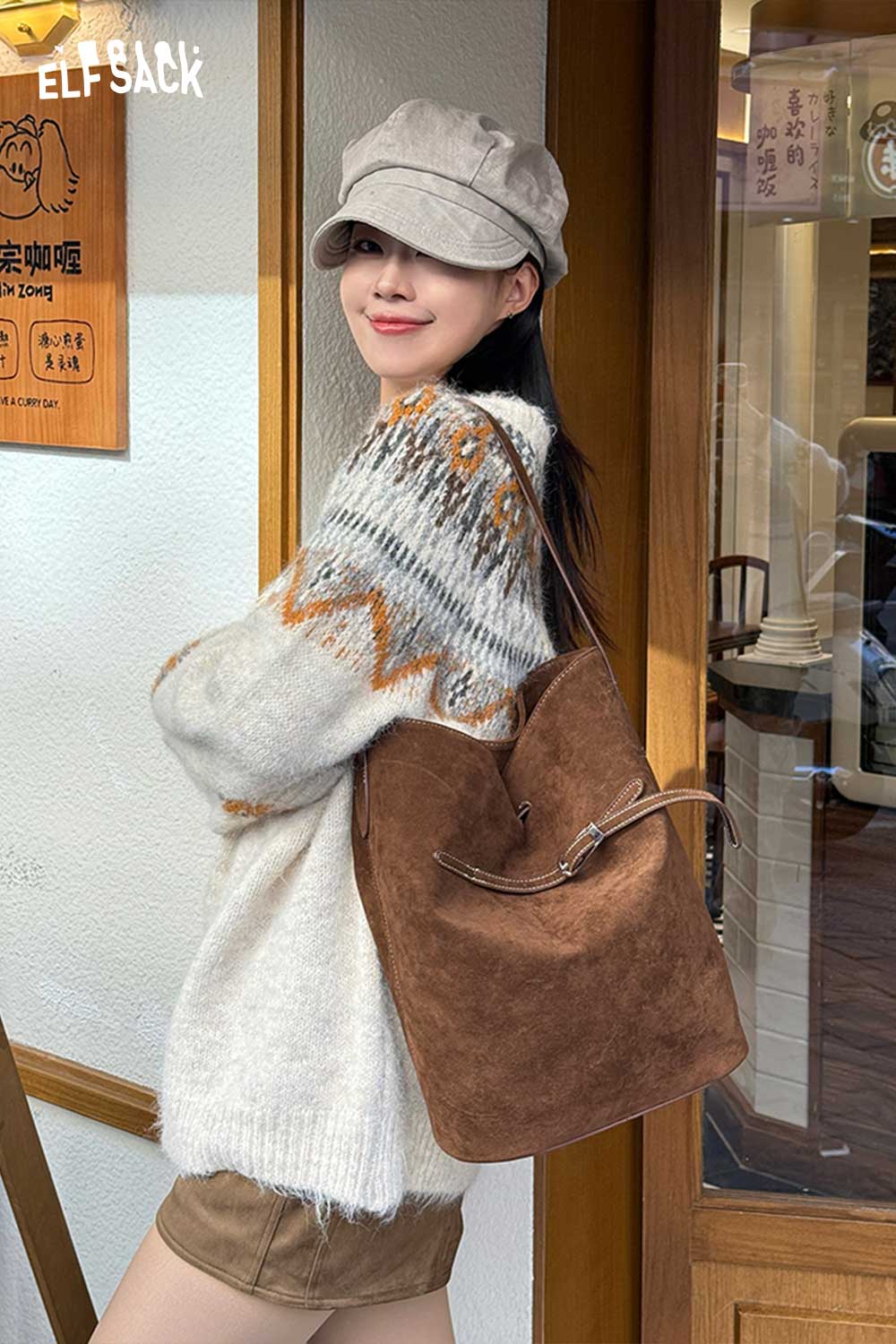 Stylish woman wearing sweater and cap, carrying a PU leather bucket bag for women