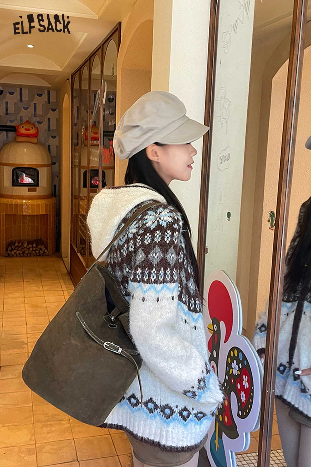 Stylish woman wearing a cozy sweater with a PU leather bucket bag for women in a chic setting