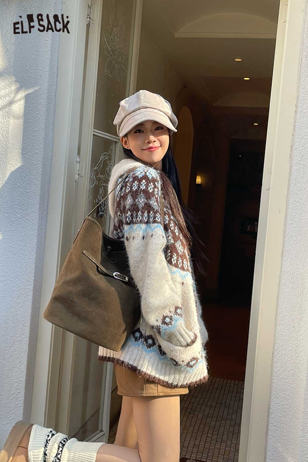 Woman wearing a cozy sweater and cap, carrying a stylish PU leather bucket bag for women