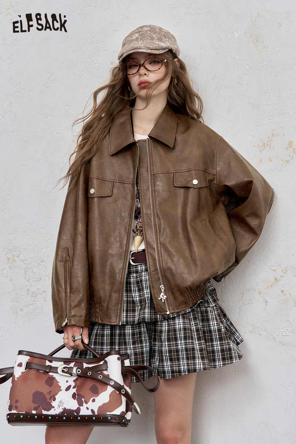 ELFSACK brown PU leather motocross jacket for women styled with a plaid skirt and accessories