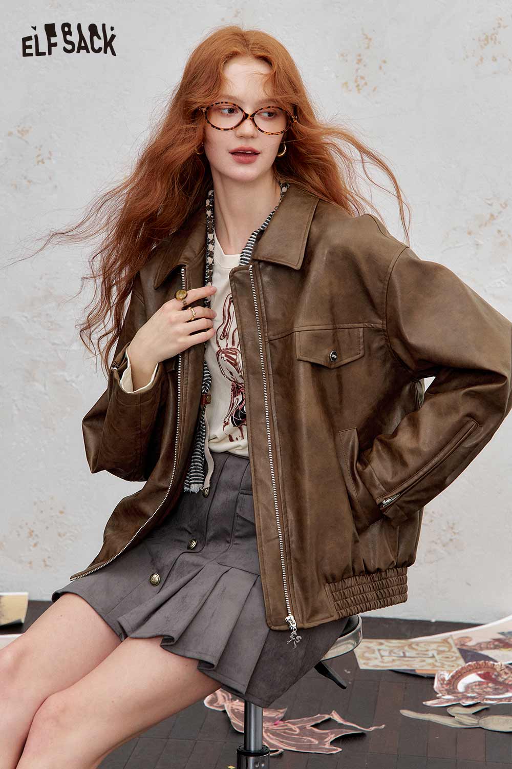 ELFSACK PU leather motocross jacket for women in brown, styled with a graphic tee and skirt
