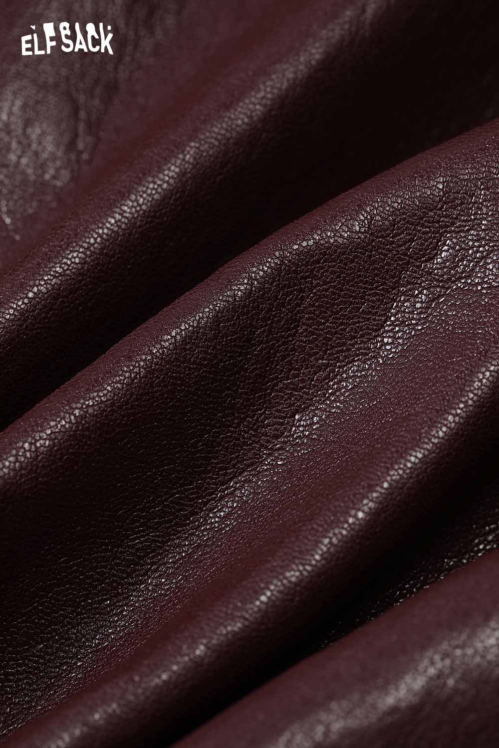 Close-up of deep burgundy fabric showcasing the texture of a PU leather oversized trench coat