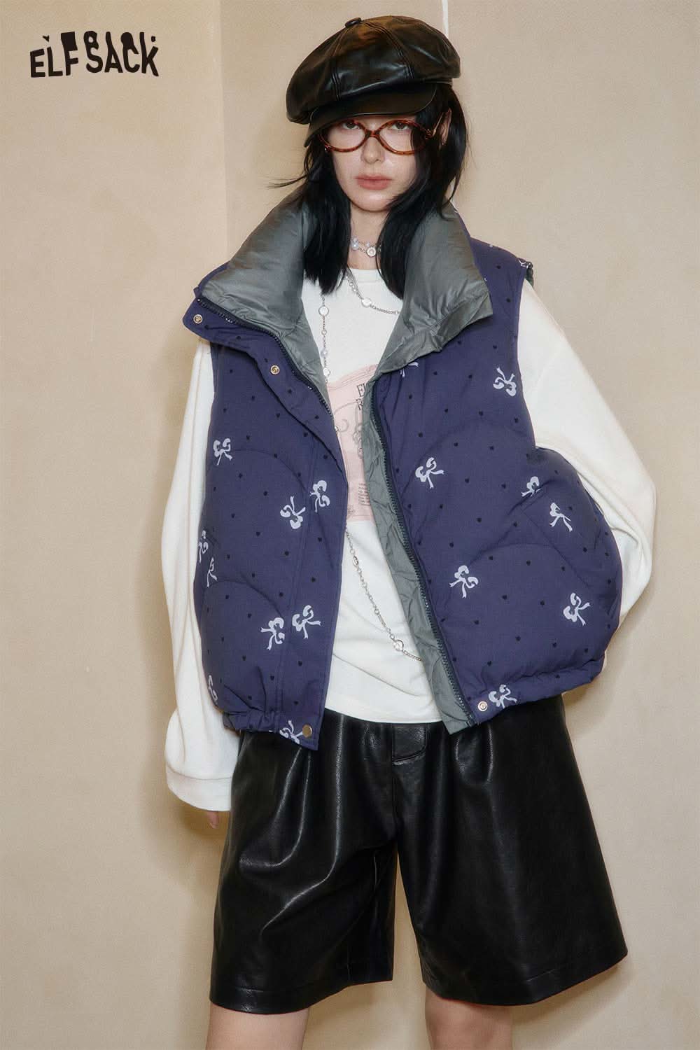 Fashionable model wearing PU leather pleated shorts paired with a stylish vest