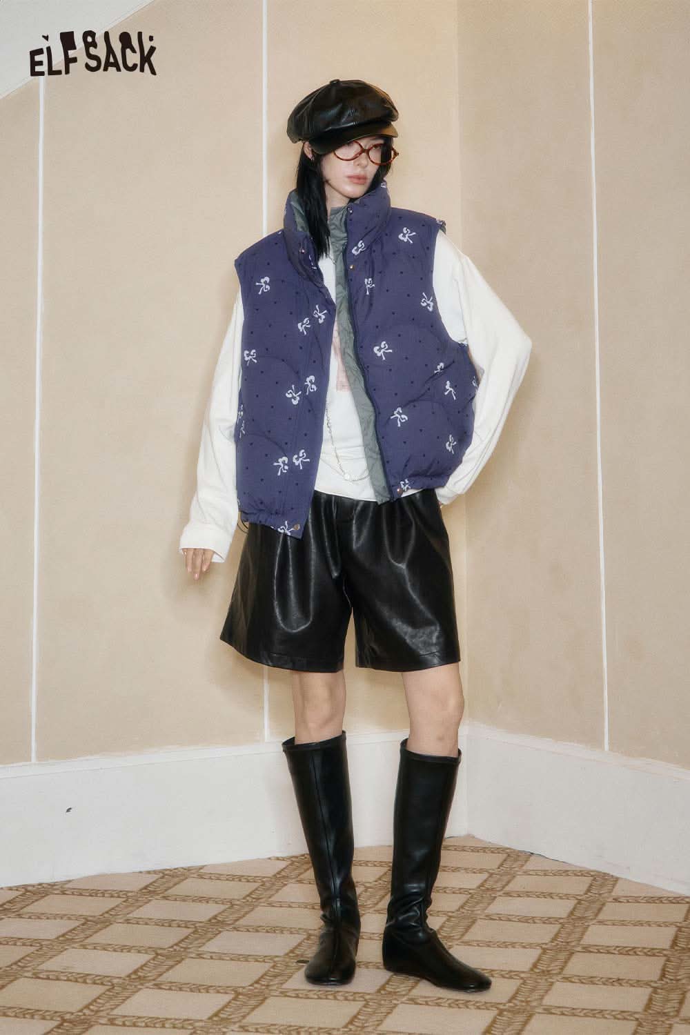 ELFSACK PU leather pleated shorts styled with a puffy vest and knee-high boots for a chic look