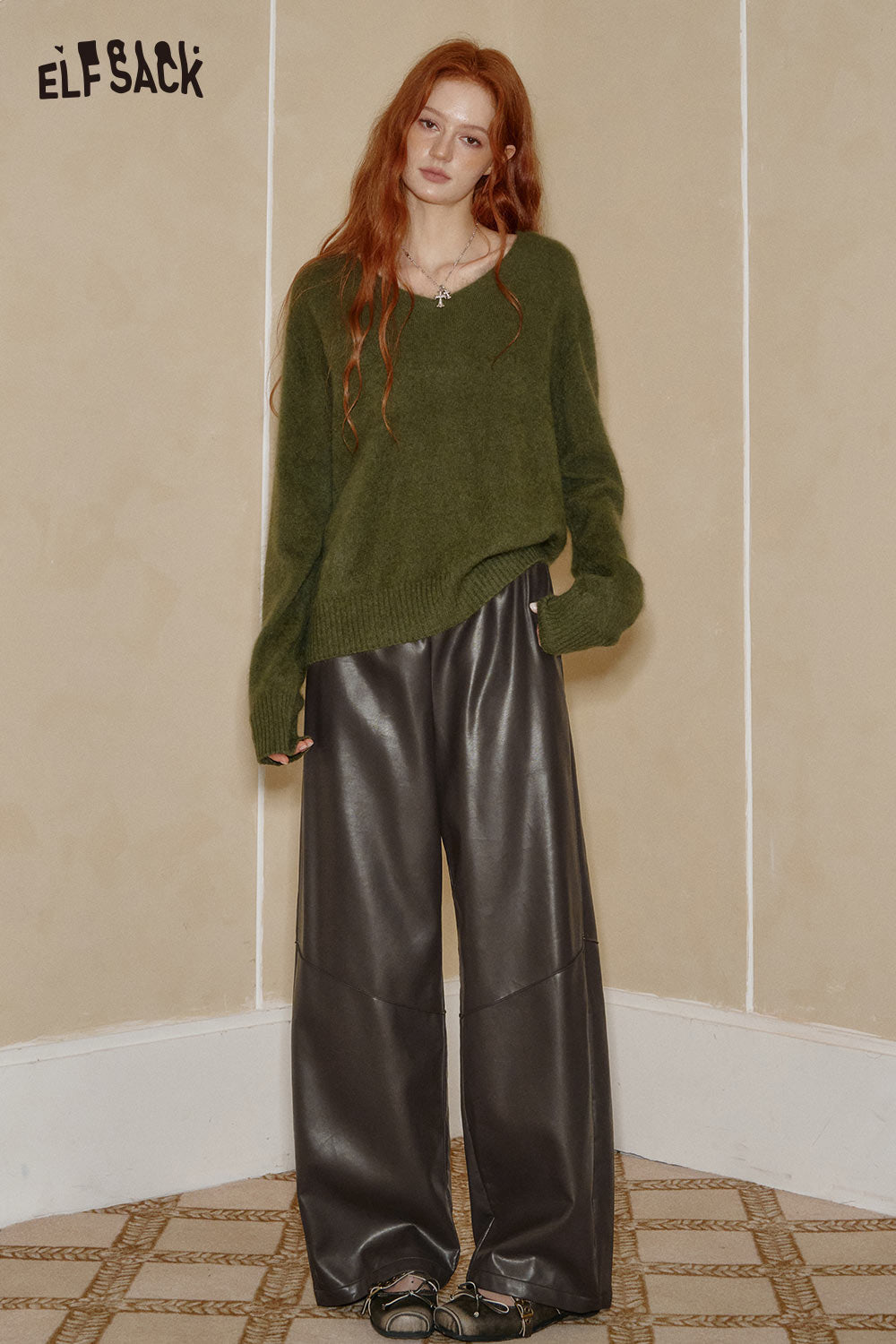 ELFSACK PU leather relaxed fit trousers in dark gray paired with a cozy green sweater