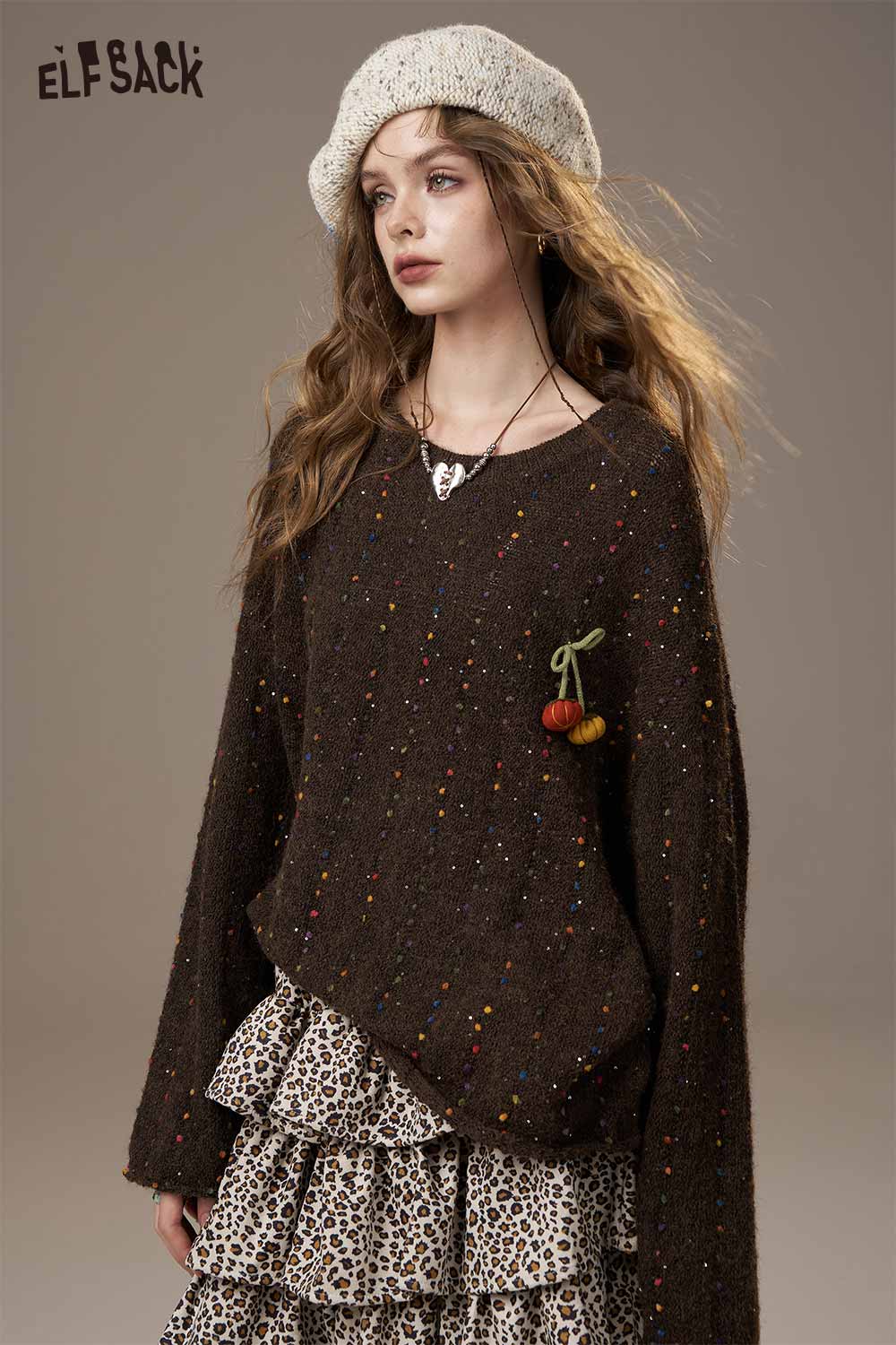 ELFSACK pumpkin motif knit sweater in brown with colorful flecks and a decorative charm