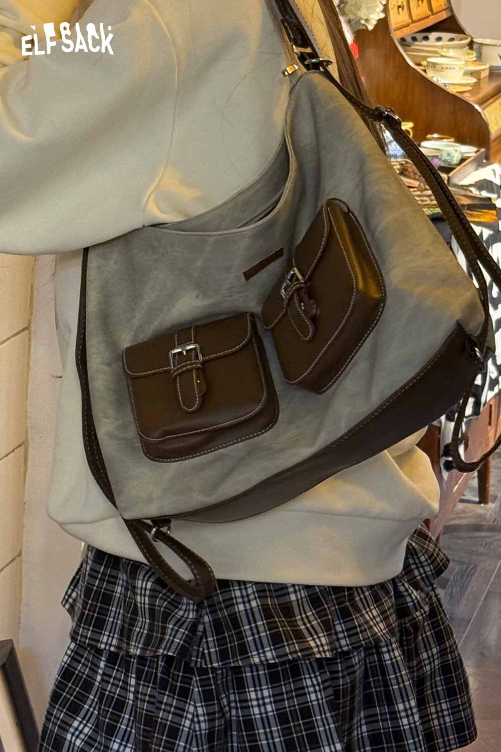 Stylish ELFSACK recycled faux leather crossbody bag with two front pockets in a casual setting