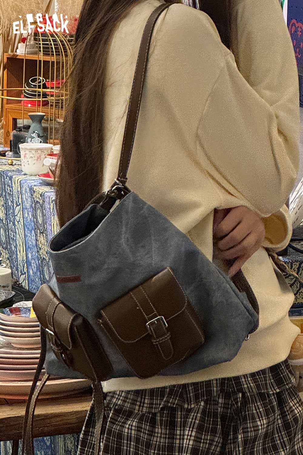 ELFSACK recycled faux leather crossbody bag in blue with a brown pocket for trendy everyday use