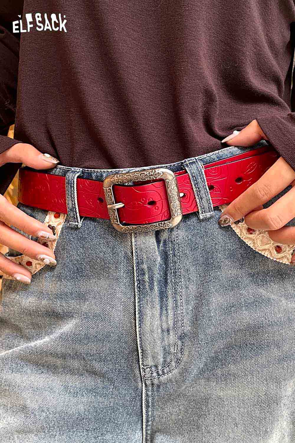ELFSACK reversible rose pattern belt in red with a silver buckle, styled with denim shorts