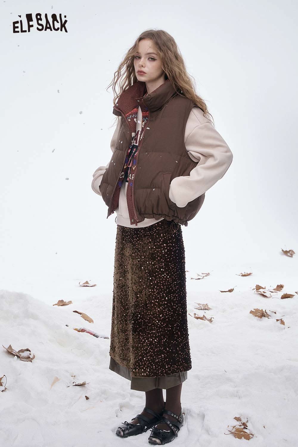 ELFSACK sequin faux leather long skirt styled with a cozy vest and sweater for a chic winter look