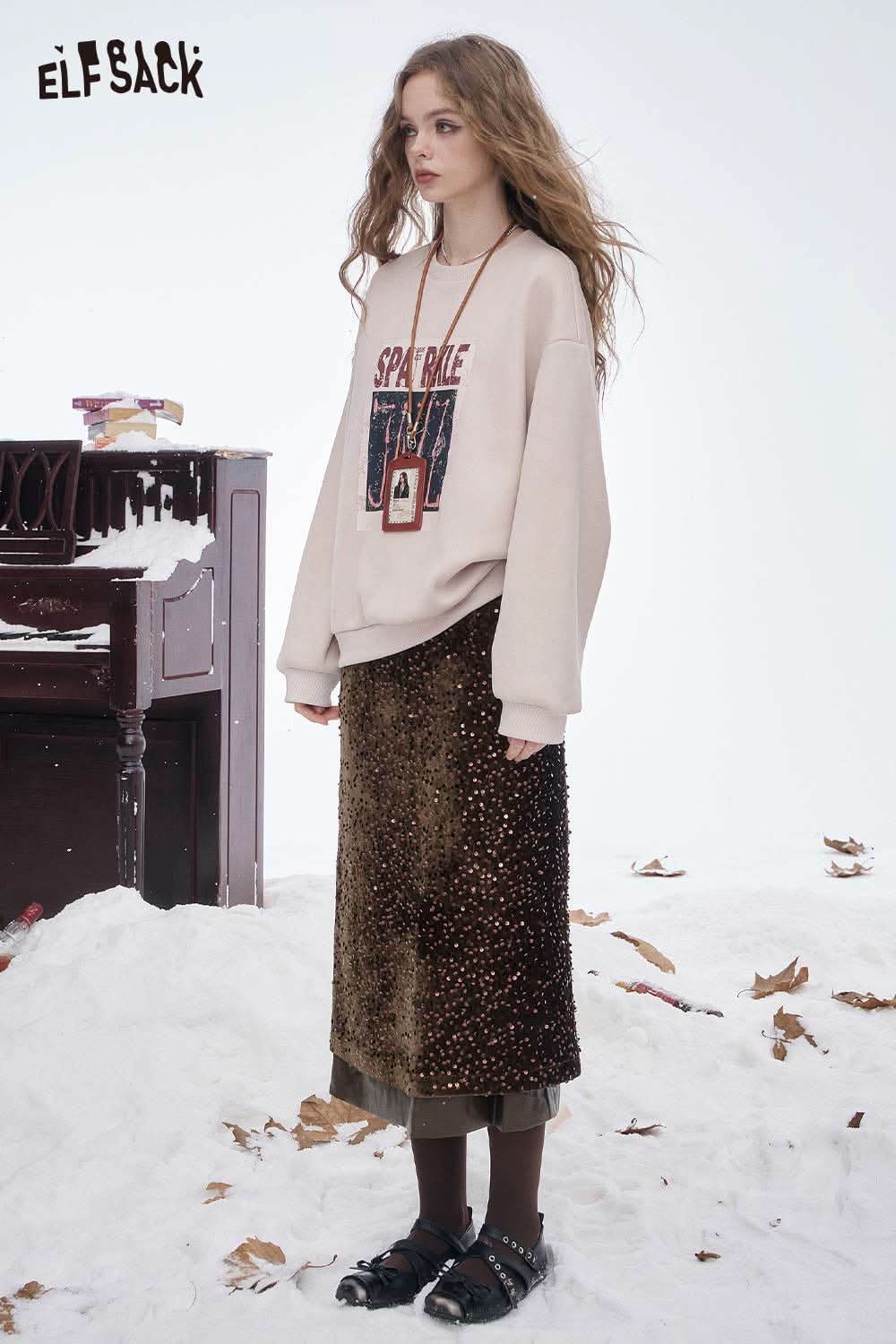 ELFSACK sequin faux leather long skirt paired with a cozy sweater for a chic winter look