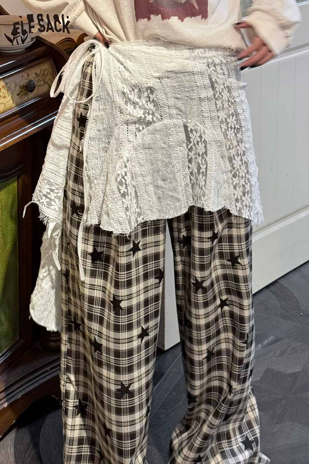 ELFSACK Sheer lace overlay skirt layered over stylish plaid pants for a fashionable look