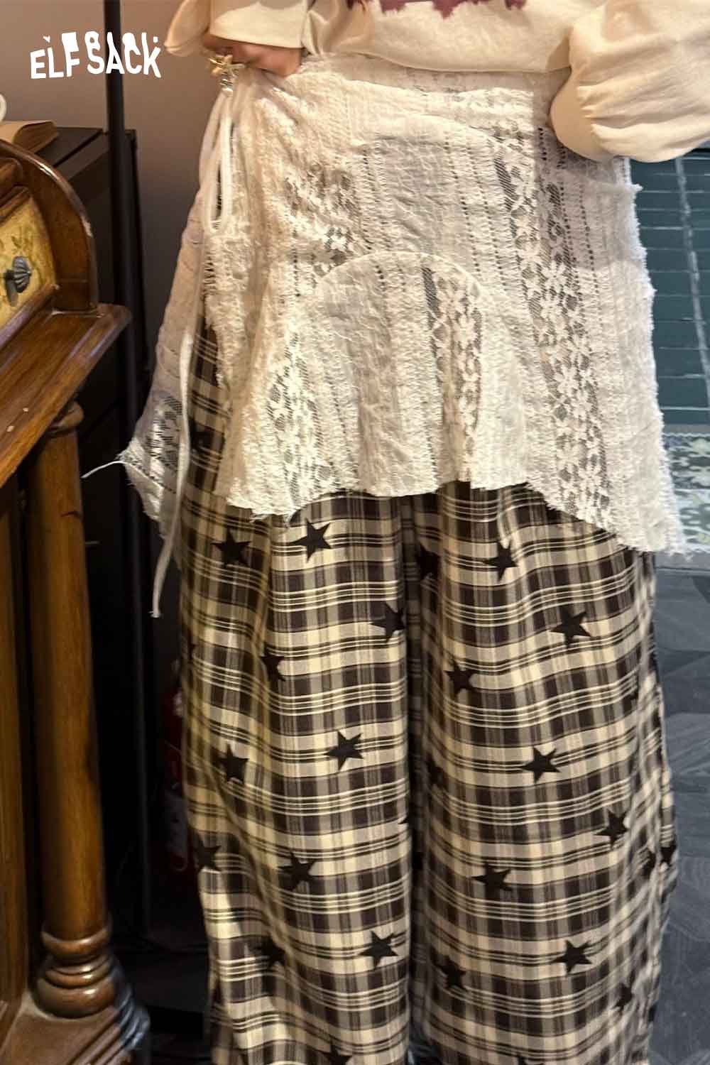 ELFSACK sheer lace overlay skirt paired with plaid wide-leg pants for a trendy layered look