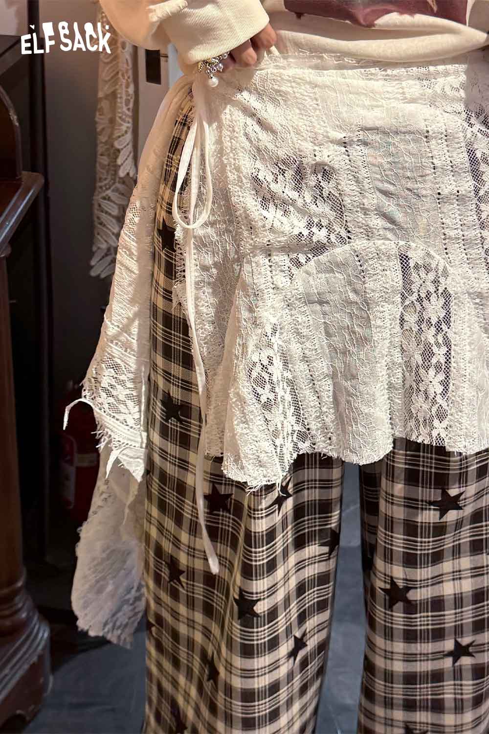 ELFSACK sheer lace overlay skirt for a stylish layered look with relaxed plaid pants