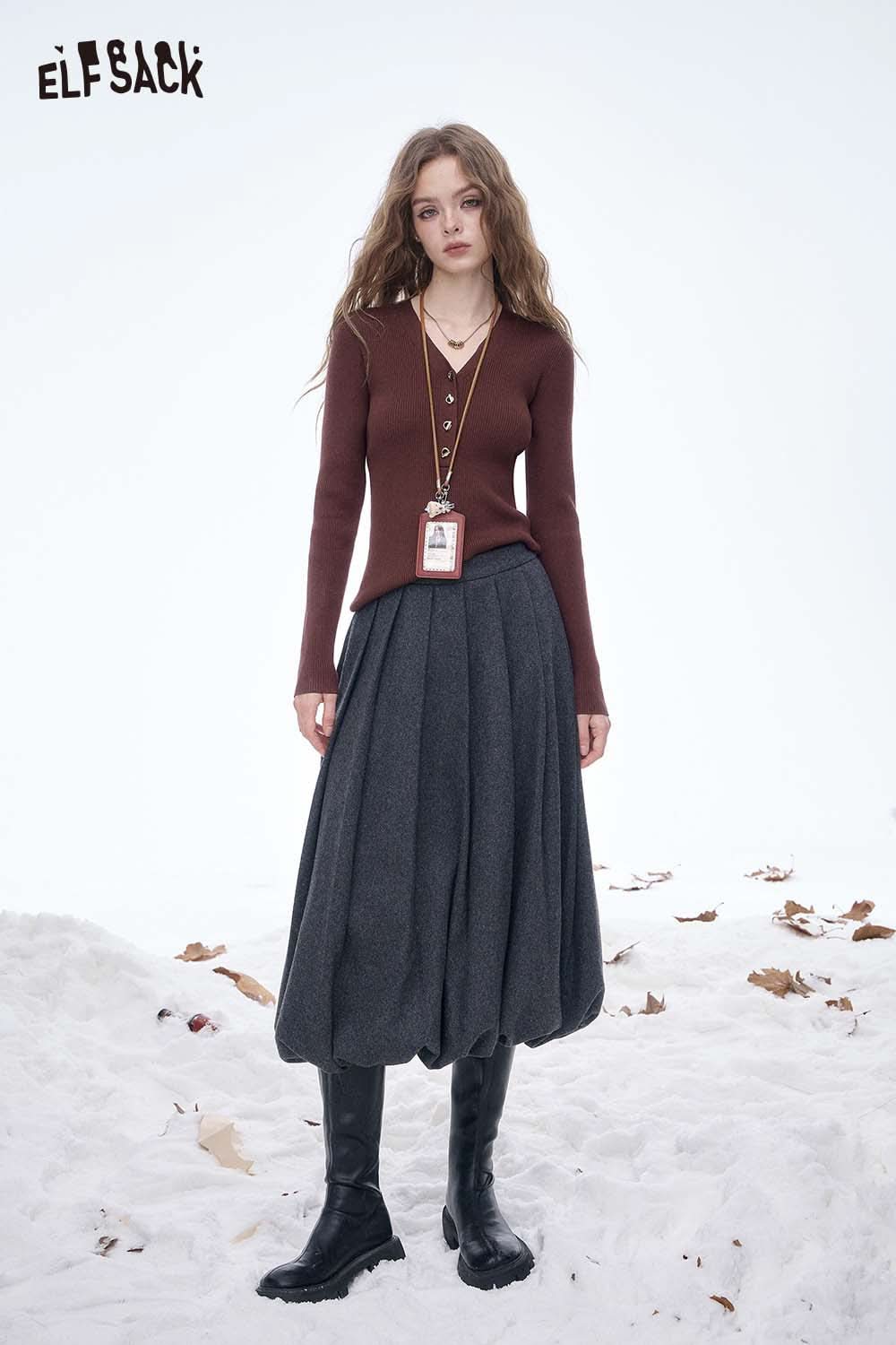 ELFSACK slim fit V neck knit sweater in brown paired with a stylish gray skirt and boots for a chic winter look