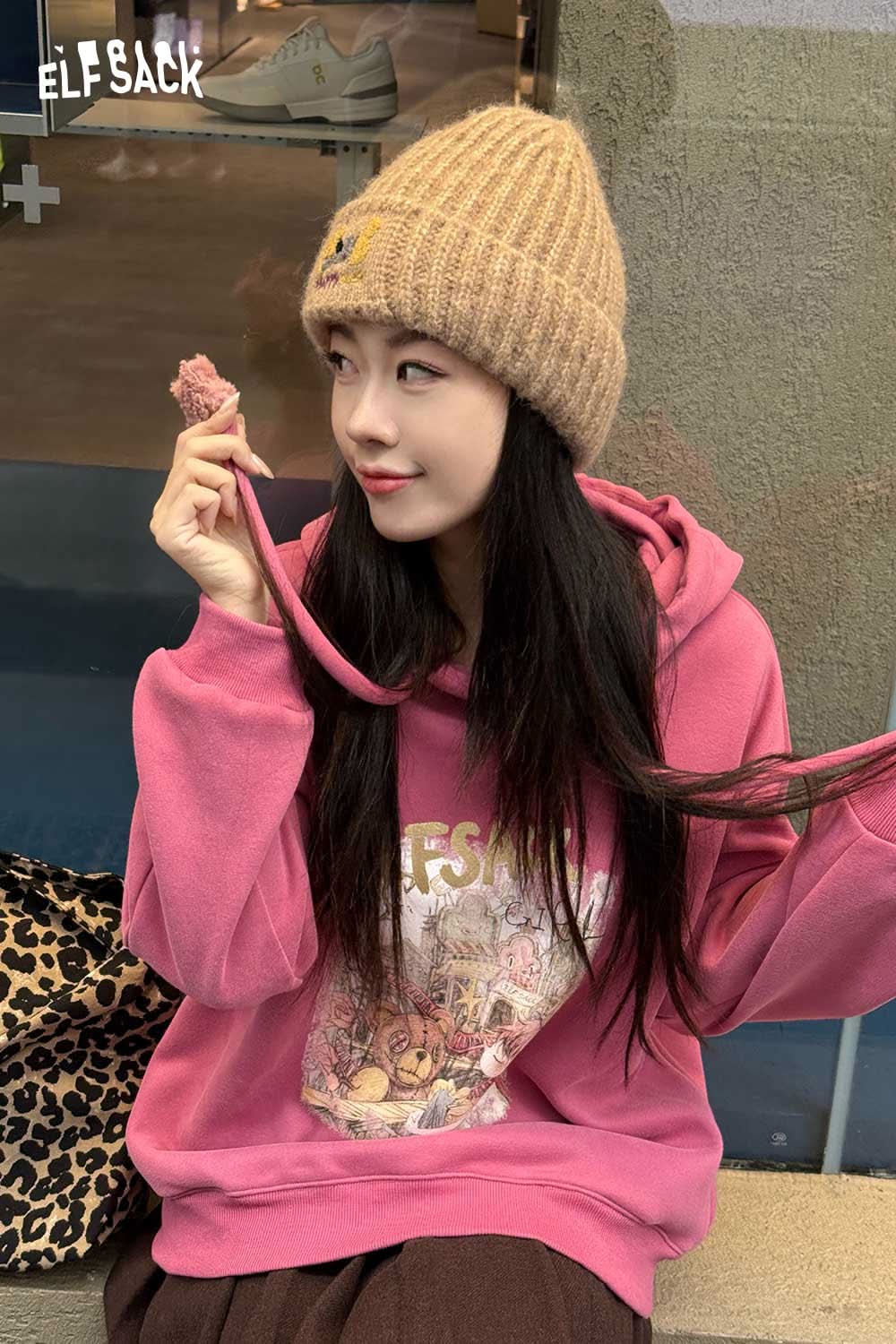 Soft dog embroidered hat in beige worn with a pink hoodie for a casual look