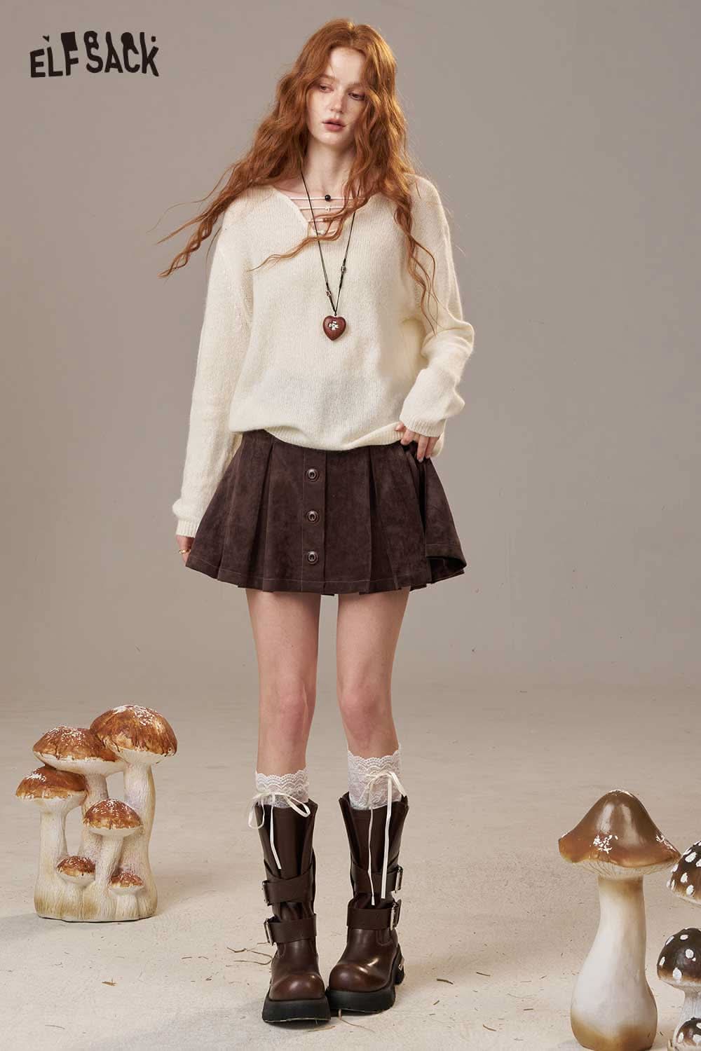 ELFSACK soft knit lace-up sweater paired with a suede skirt, featuring a relaxed fit and stylish details