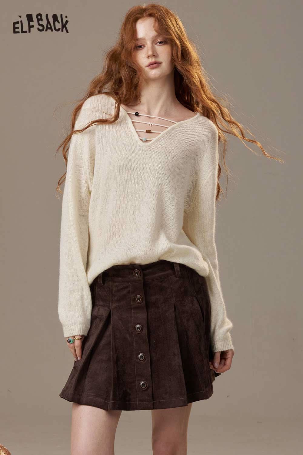 ELFSACK soft knit lace-up sweater in cream paired with a brown button-up skirt for a casual look