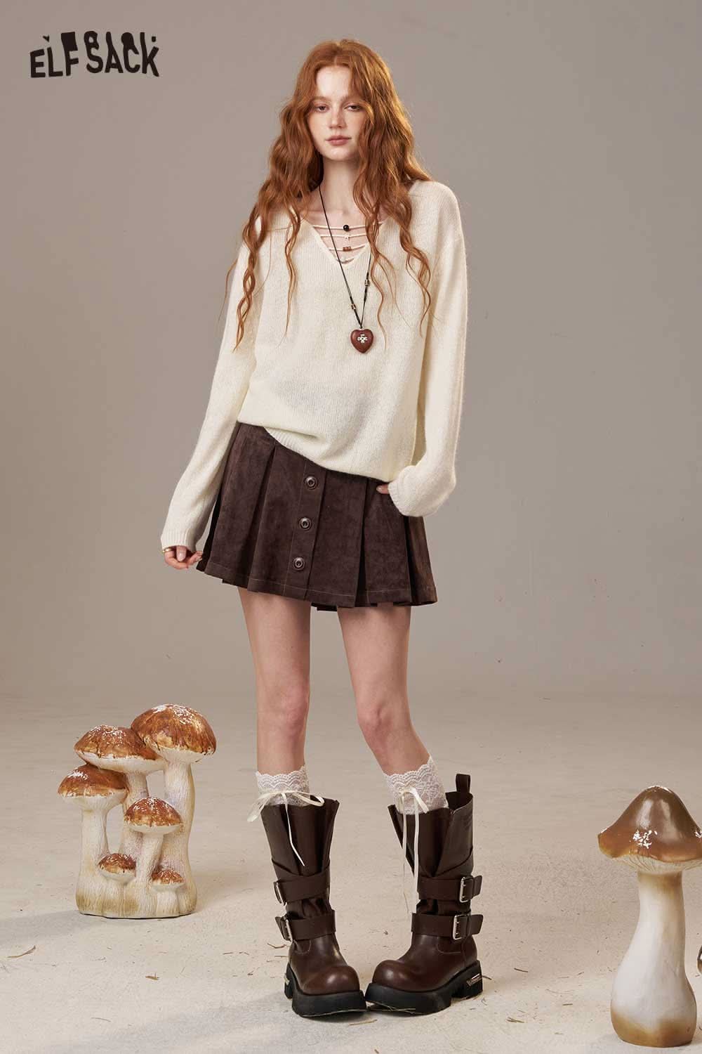 ELFSACK soft knit lace-up sweater styled with a brown skirt and tall boots for a trendy look