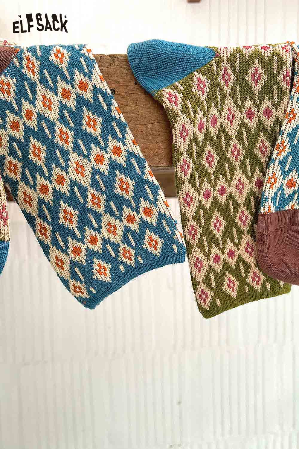 Colorful ELFSACK soft patterned ankle socks displayed on a wooden rack with vibrant designs