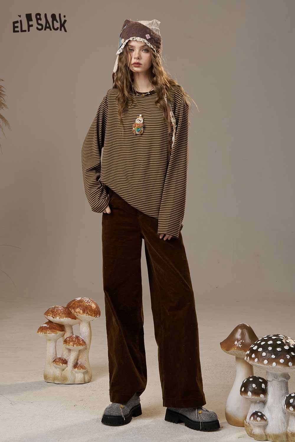 ELFSACK soft striped long sleeve tee worn with wide-leg pants and a unique hat in a stylish setting