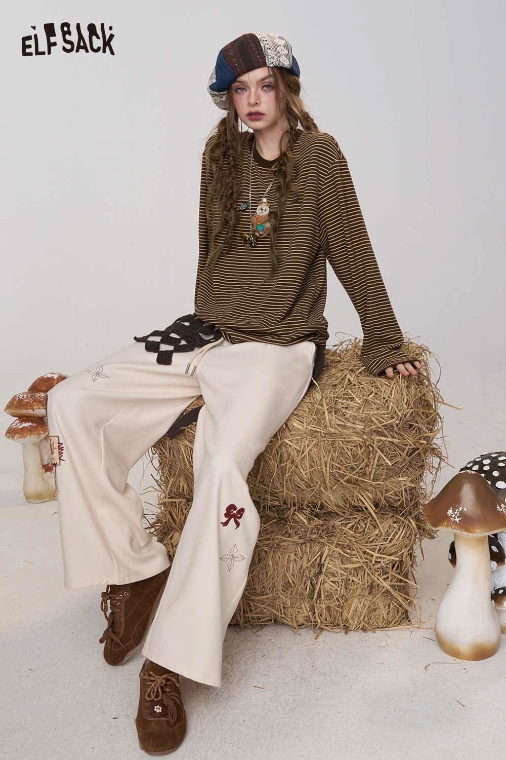 ELFSACK soft striped long sleeve tee styled with cream wide-leg pants for a trendy look