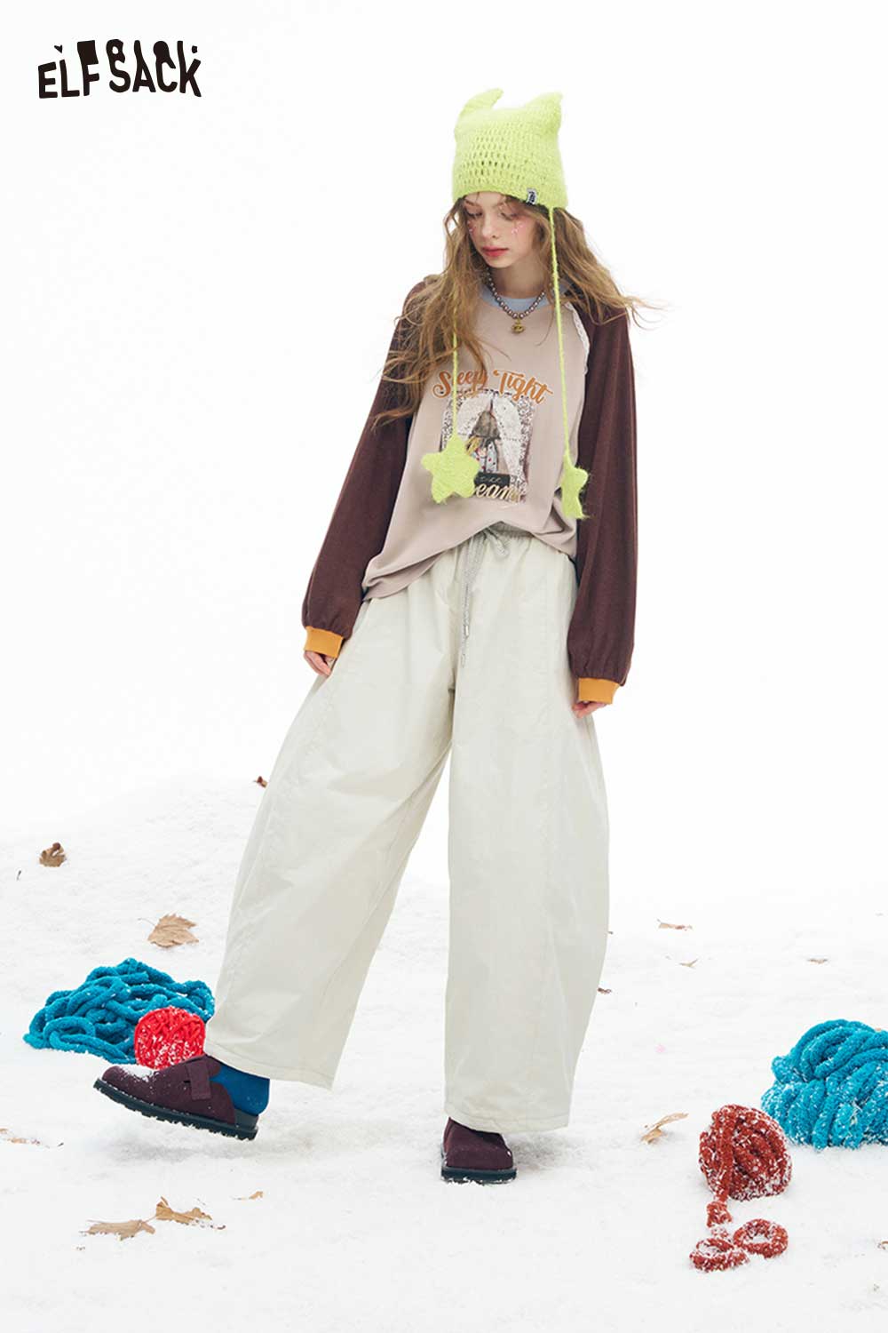 ELFSACK soft wide leg pants for women in light color, paired with a graphic tee and winter accessories