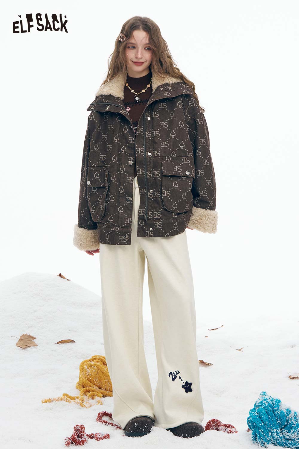 ELFSACK star graphic floor length pants in cream paired with a stylish brown jacket