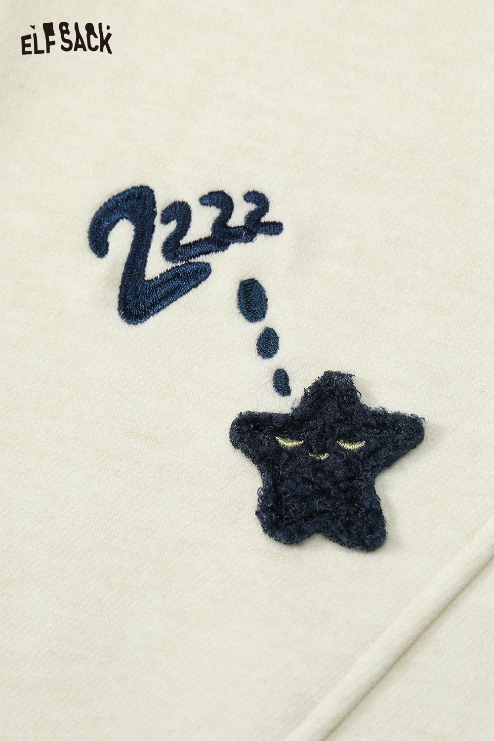 Detailed view of ELFSACK star graphic floor length pants featuring embroidered star and dreamy cloud design