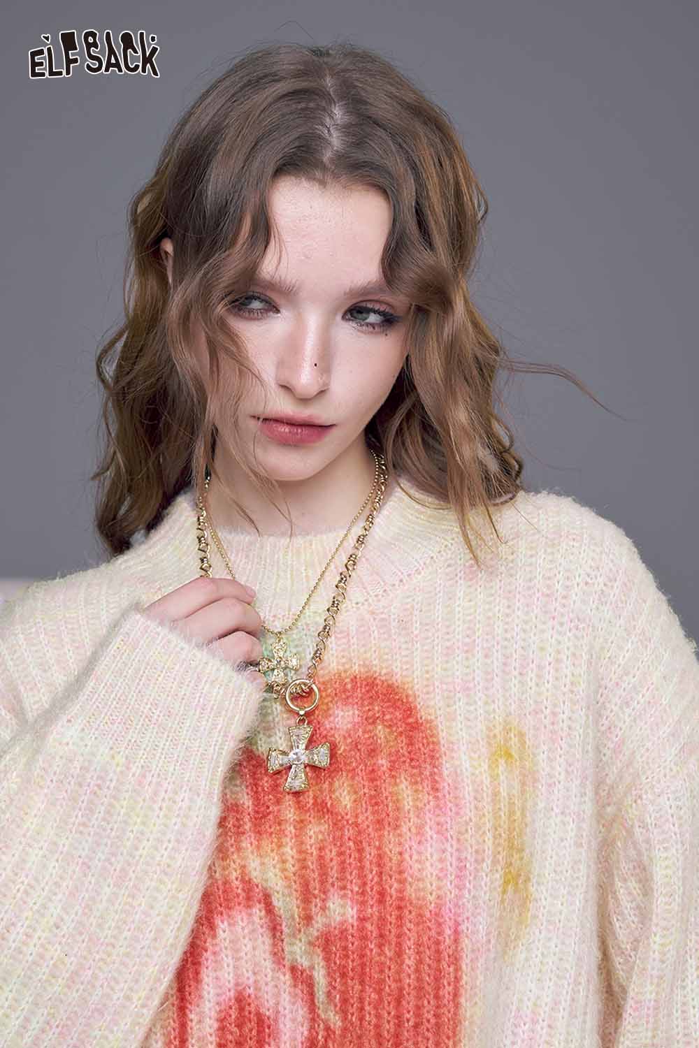 ELFSACK strawberry graphic knit sweater in soft pastel colors, styled with a gold chain necklace