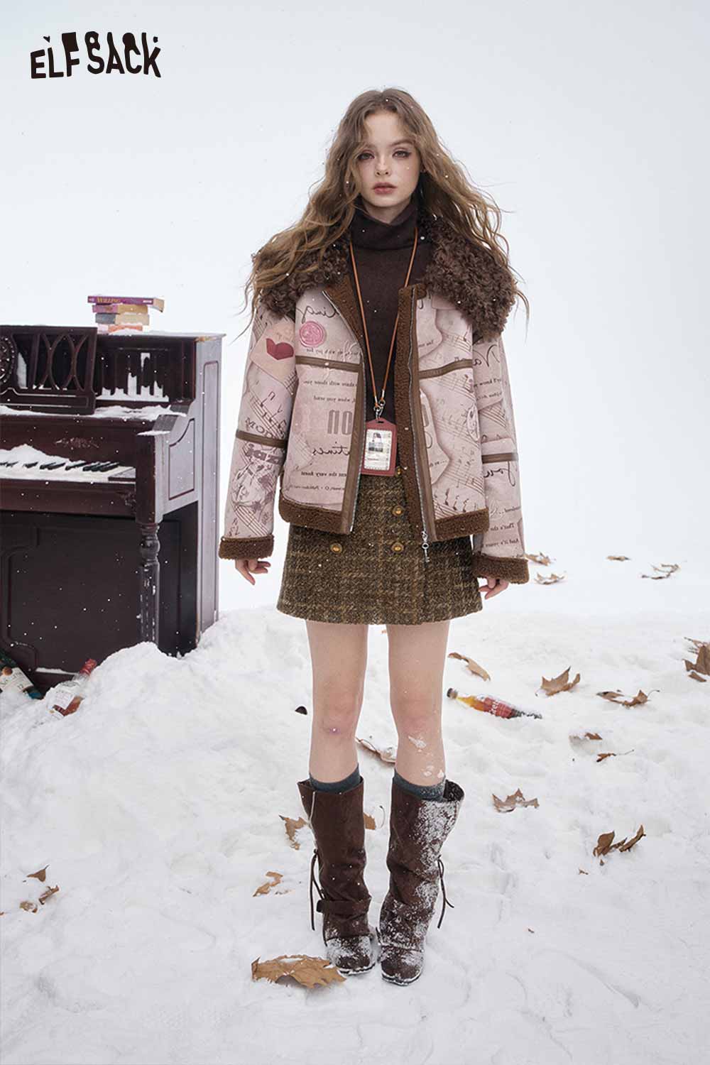 Model wearing a striped gold button A-line skirt paired with a stylish jacket in a winter setting
