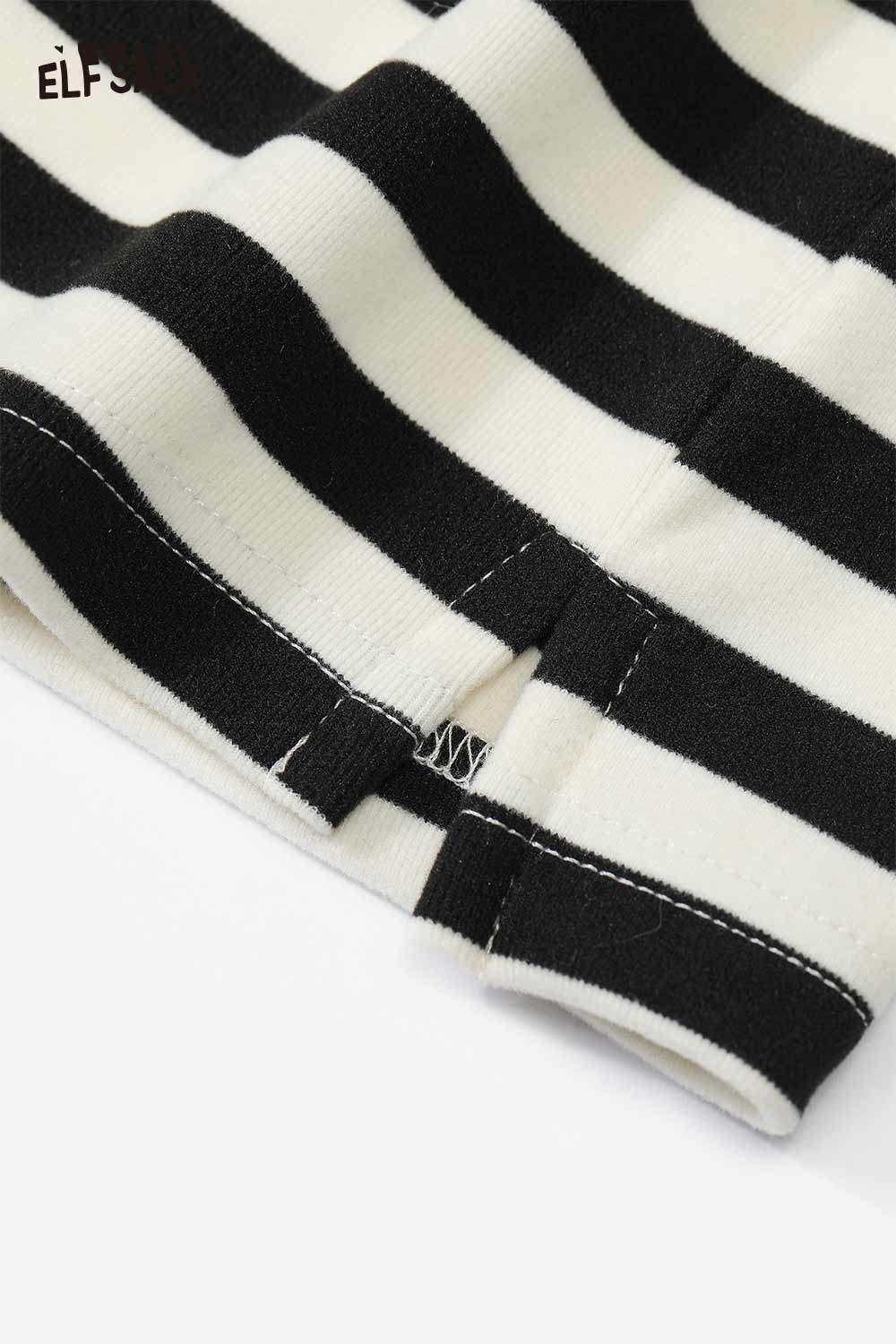 Close-up of ELFSACK striped high neck graphic t-shirt for women with bold black and white stripes
