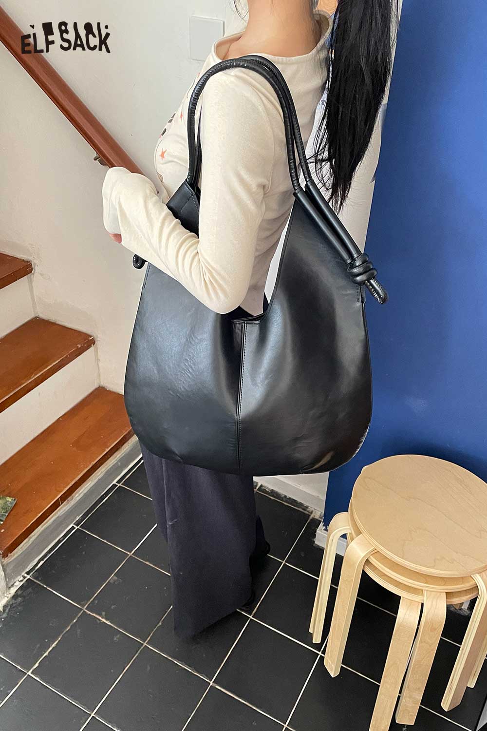 Stylish black structured PU tote bag for women featuring a modern design and comfortable straps