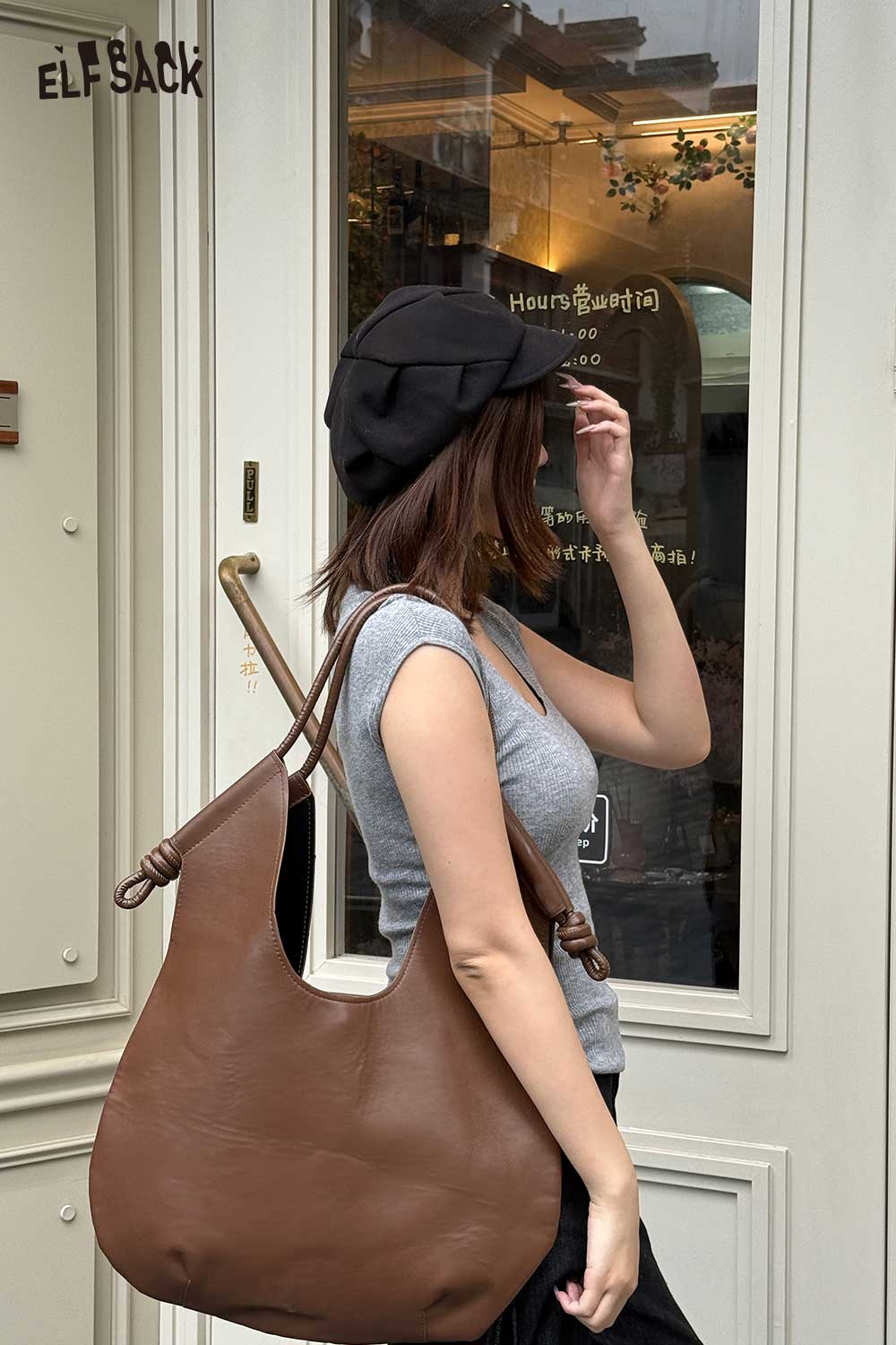 Stylish woman wearing a cap and gray top, carrying a structured PU tote bag for women in brown