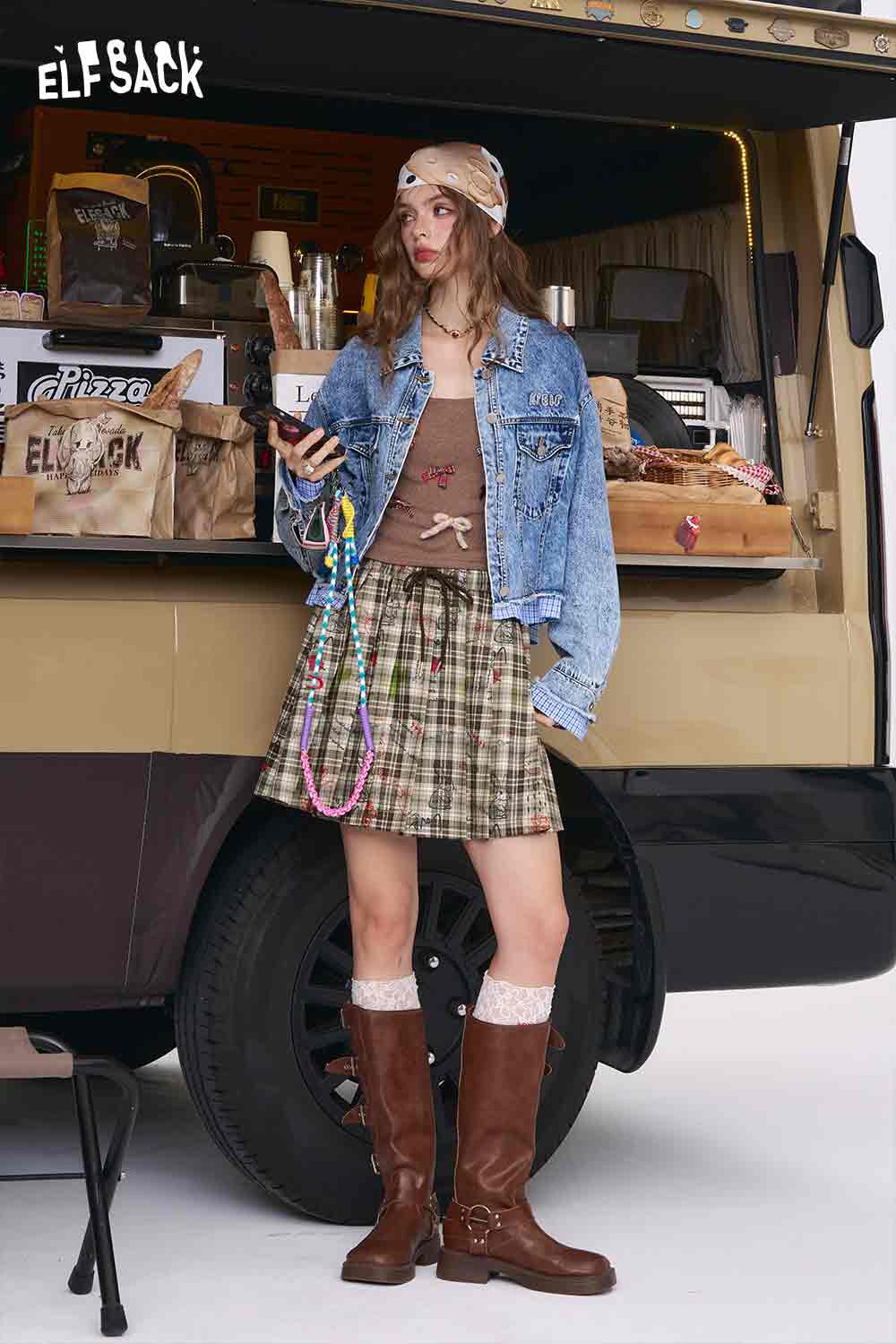 ELFSACK model wearing college style plaid mini skirt with denim jacket brown knee boots and headscarf
