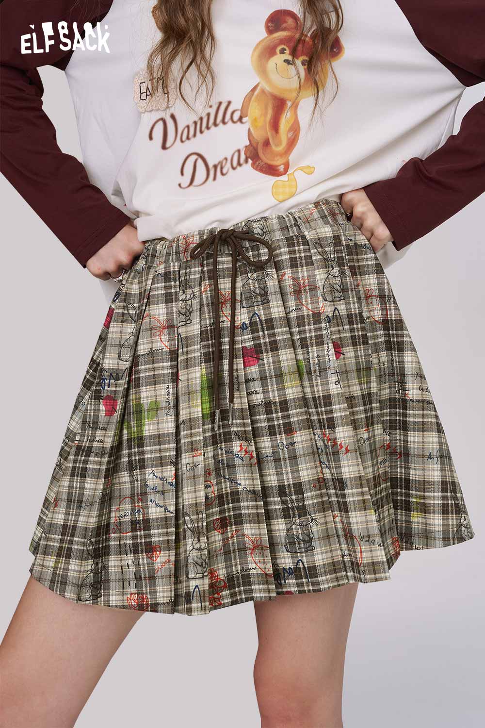 ELFSACK college style plaid mini skirt in olive green pleated design with drawstring waist and whimsical print