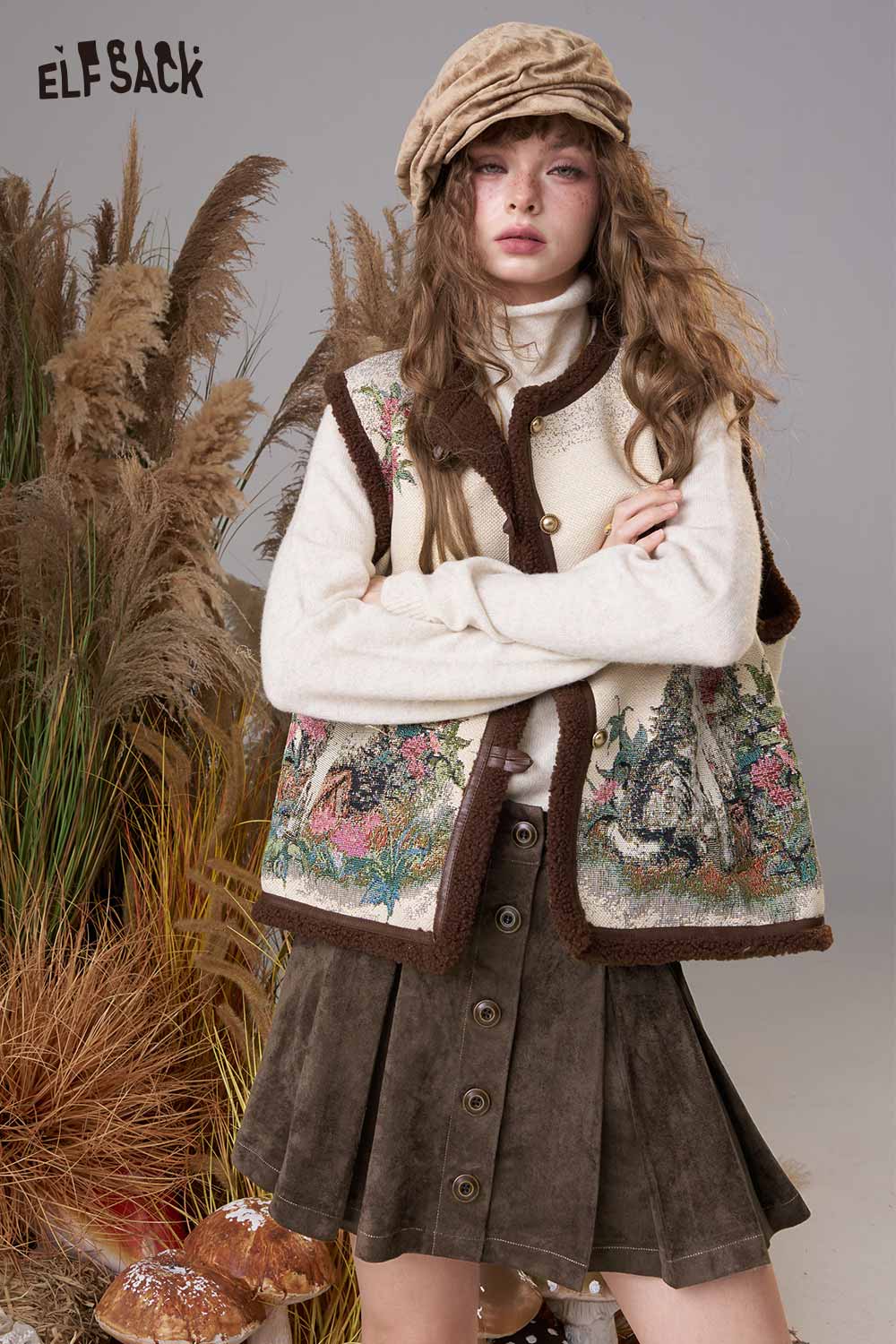 Model wearing a stylish suede A-line mini skirt paired with a decorative vest and cozy sweater.