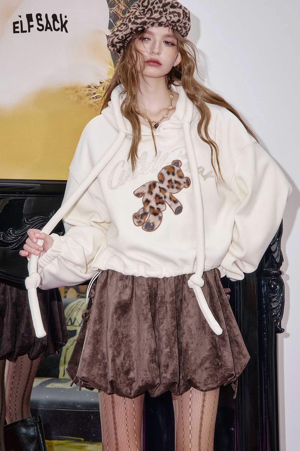 ELFSACK suede bloomer mini skirt in brown, styled with a cozy hoodie and patterned accessories