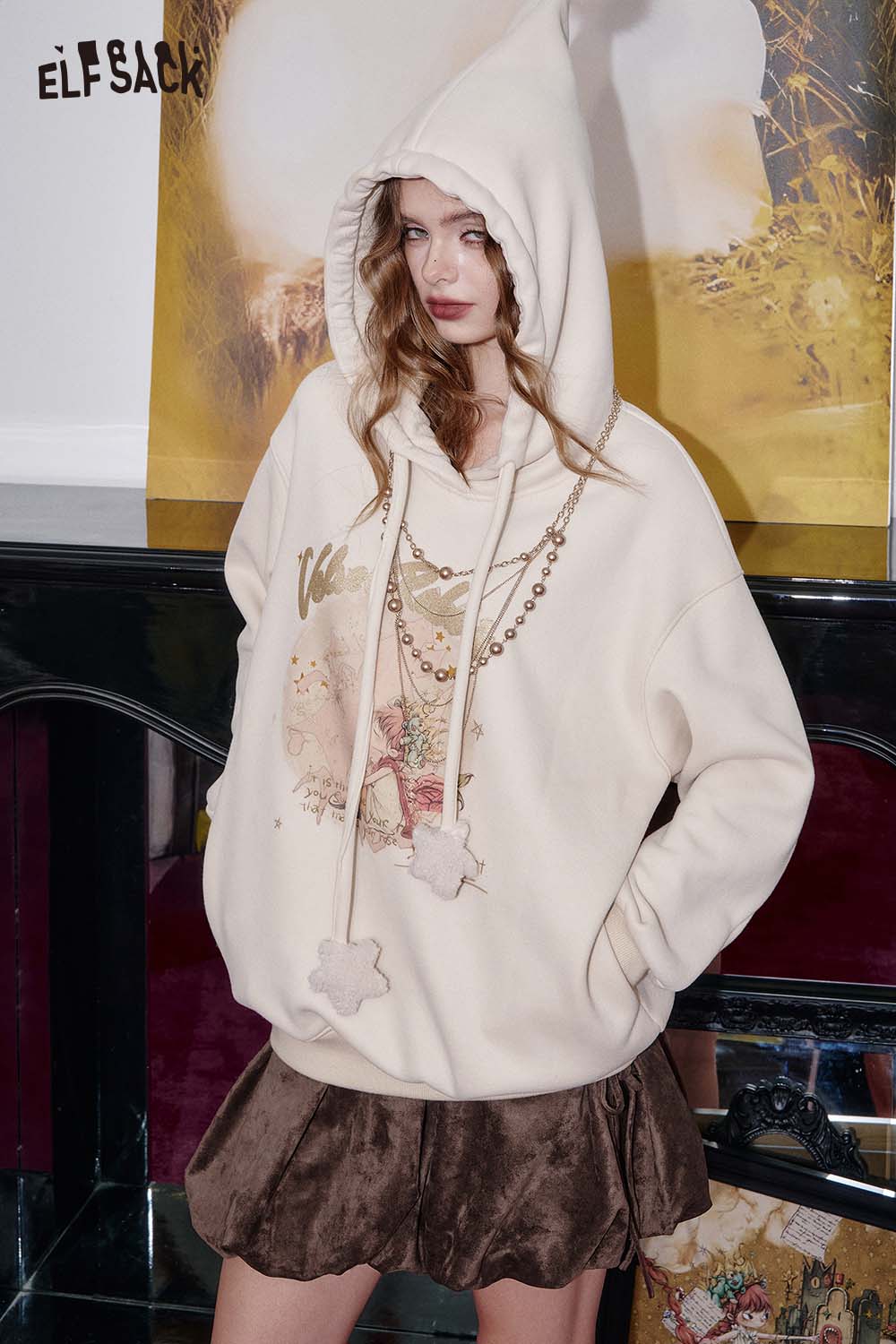 ELFSACK suede bloomer mini skirt styled with a cozy hoodie for a trendy casual look