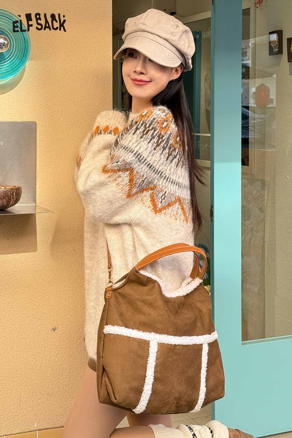 Stylish model wearing a cozy sweater holding a suede lambswool crossbody bag for a chic look